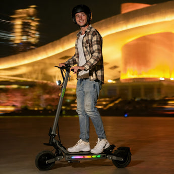 Person riding an vipcoo vs2 pro electric scooter at night with a blurred cityscape background
